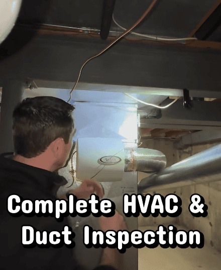 Professional inspecting HVAC equipment and ductwork as part of an indoor environmental assessment.